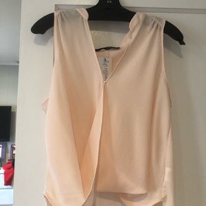 Light pink top with extended back. Tag still on